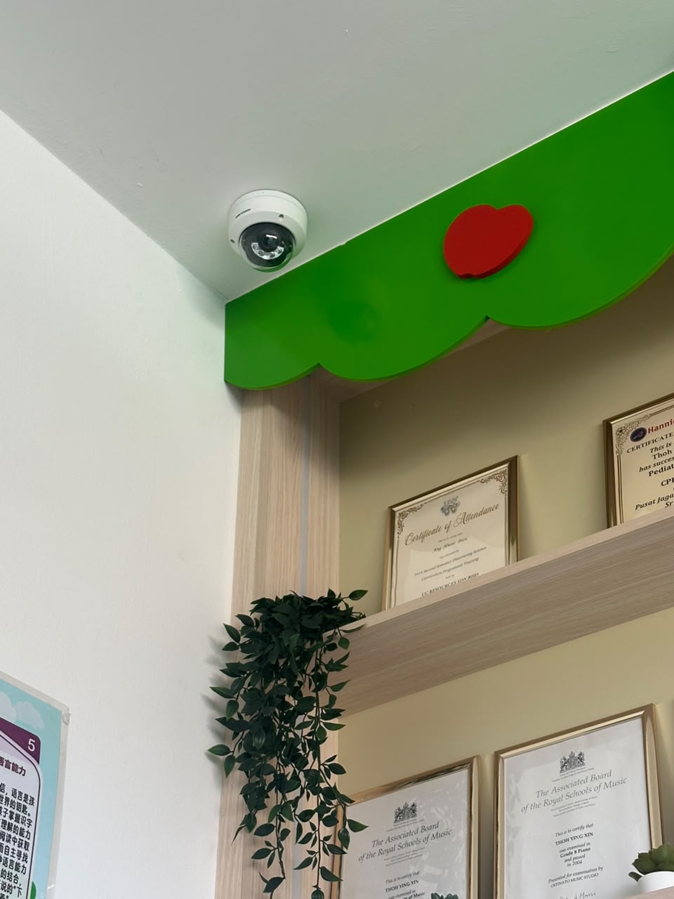 CCTV camera mounted at the entrance corner near the reception area