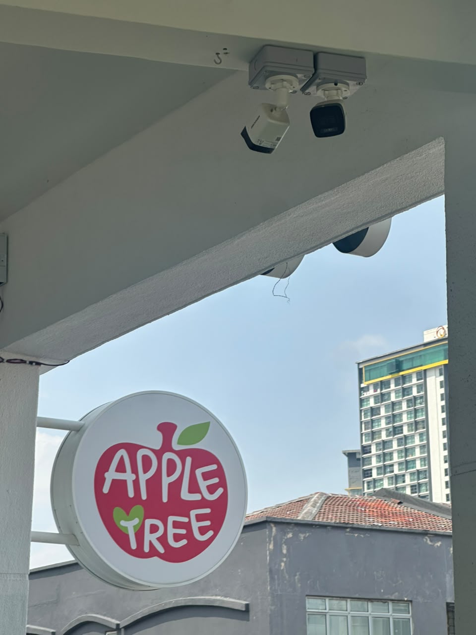 Outdoor CCTV cameras mounted above the centre's storefront signage