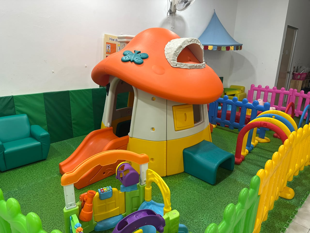 Mushroom-shaped toddler playhouse with slide and soft padded corner
